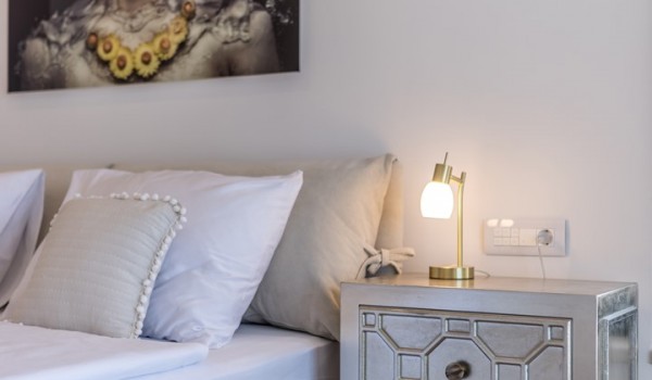 Bedroom of Croatia luxury holiday villa with king-size bed and night stand with lamp for rent