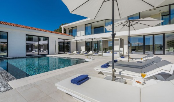 Sun loungers by the private pool of a Croatia luxury seafront villa Eden Land with sauna and jacuzzi in Istria