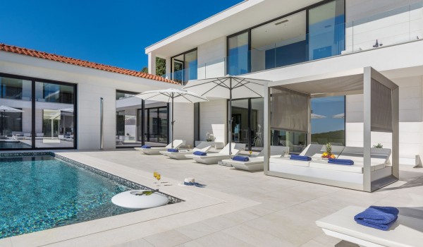 Sun loungers by the private pool of a Croatia luxury seafront villa Eden Land with sauna and jacuzzi in Istria