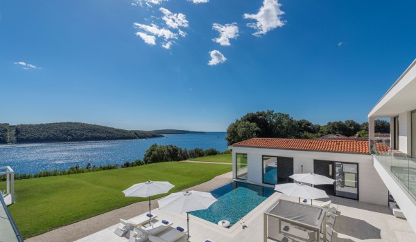Sun loungers by the private pool of a Croatia luxury seafront villa Eden Land with sauna and jacuzzi in Istria