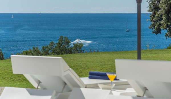 Sun loungers with sea view by the private pool of a Croatia luxury seafront villa Eden Land with sauna and jacuzzi in Istria