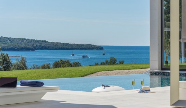 Sun loungers with sea view by the private pool of a Croatia luxury seafront villa Eden Land with sauna and jacuzzi in Istria
