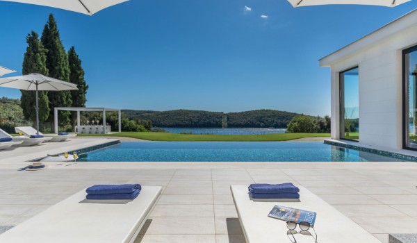 Sun loungers with sea view by the private pool of a Croatia luxury seafront villa Eden Land with sauna and jacuzzi in Istria