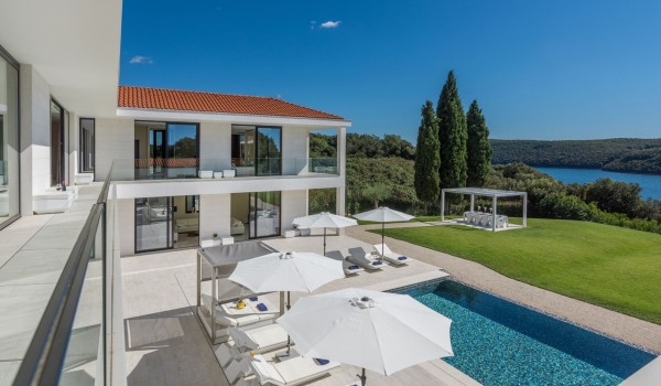 Sun loungers with sea view by the private pool of a Croatia luxury seafront villa Eden Land with sauna and jacuzzi in Istria