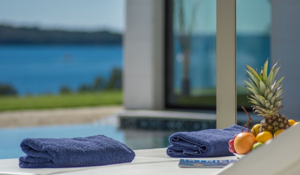 Sun loungers with sea view by the private pool of a Croatia luxury seafront villa Eden Land with sauna and jacuzzi in Istria