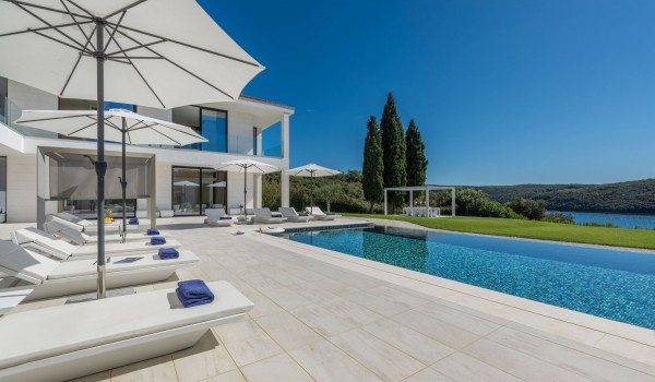 Sun loungers with sea view by the private pool of a Croatia luxury seafront villa Eden Land with sauna and jacuzzi in Istria