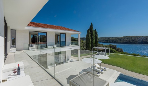 Sun loungers with sea view by the private pool of a Croatia luxury seafront villa Eden Land with sauna and jacuzzi in Istria