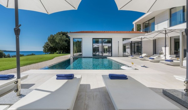Sun loungers with sea view by the private pool of a Croatia luxury seafront villa Eden Land with sauna and jacuzzi in Istria