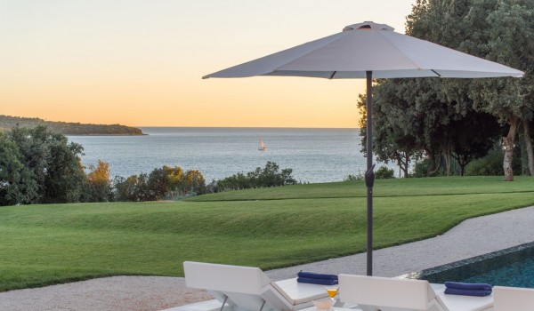 Sun loungers with sea view by the private pool of a Croatia luxury seafront villa Eden Land with sauna and jacuzzi in Istria