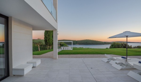 View of the covered outdoor dining table in the garden of a Croatia luxury pet-friendly villa with concierge service and parking in Istria