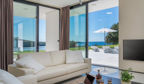 Comfortable sofas in a living room with direct entrance to the terrace of a Croatia luxury pet-friendly villa by the sea in Istria