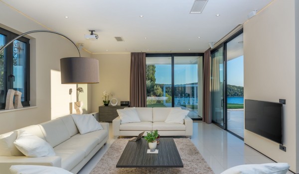 Comfortable sofas in a living room with direct entrance to the terrace of a Croatia luxury pet-friendly villa by the sea in Istria