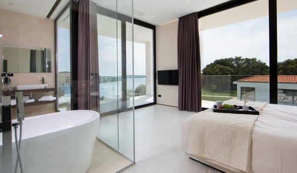 King size bed in a bedroom with en suite bathroom and sea view in a Croatia luxury villa Eden Land in Istria
