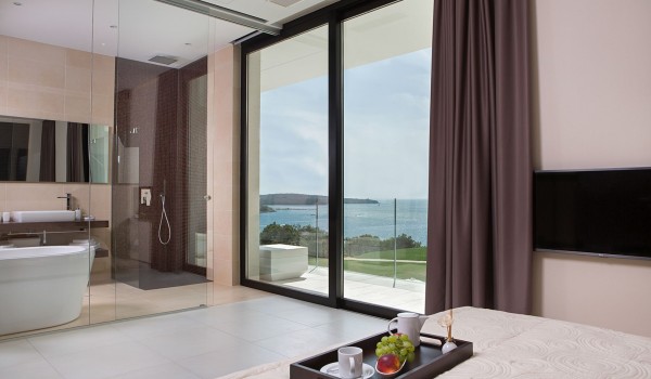 King size bed in a bedroom with en suite bathroom and sea view in a Croatia luxury villa Eden Land in Istria