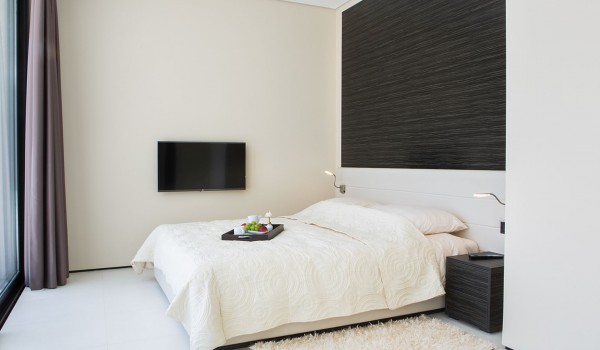 King size bed in a bedroom with en suite bathroom and sea view in a Croatia luxury villa Eden Land in Istria