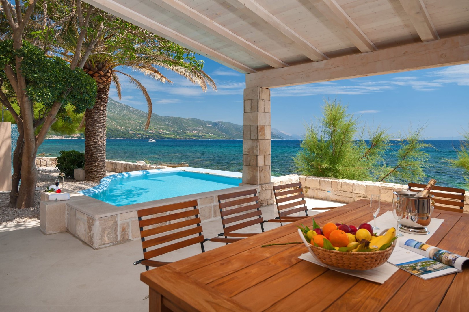 Outdoor dining area of Croatian luxury beachfront Villa Gracia Grande in Orebić with private pool and sea view for vacation and rent.