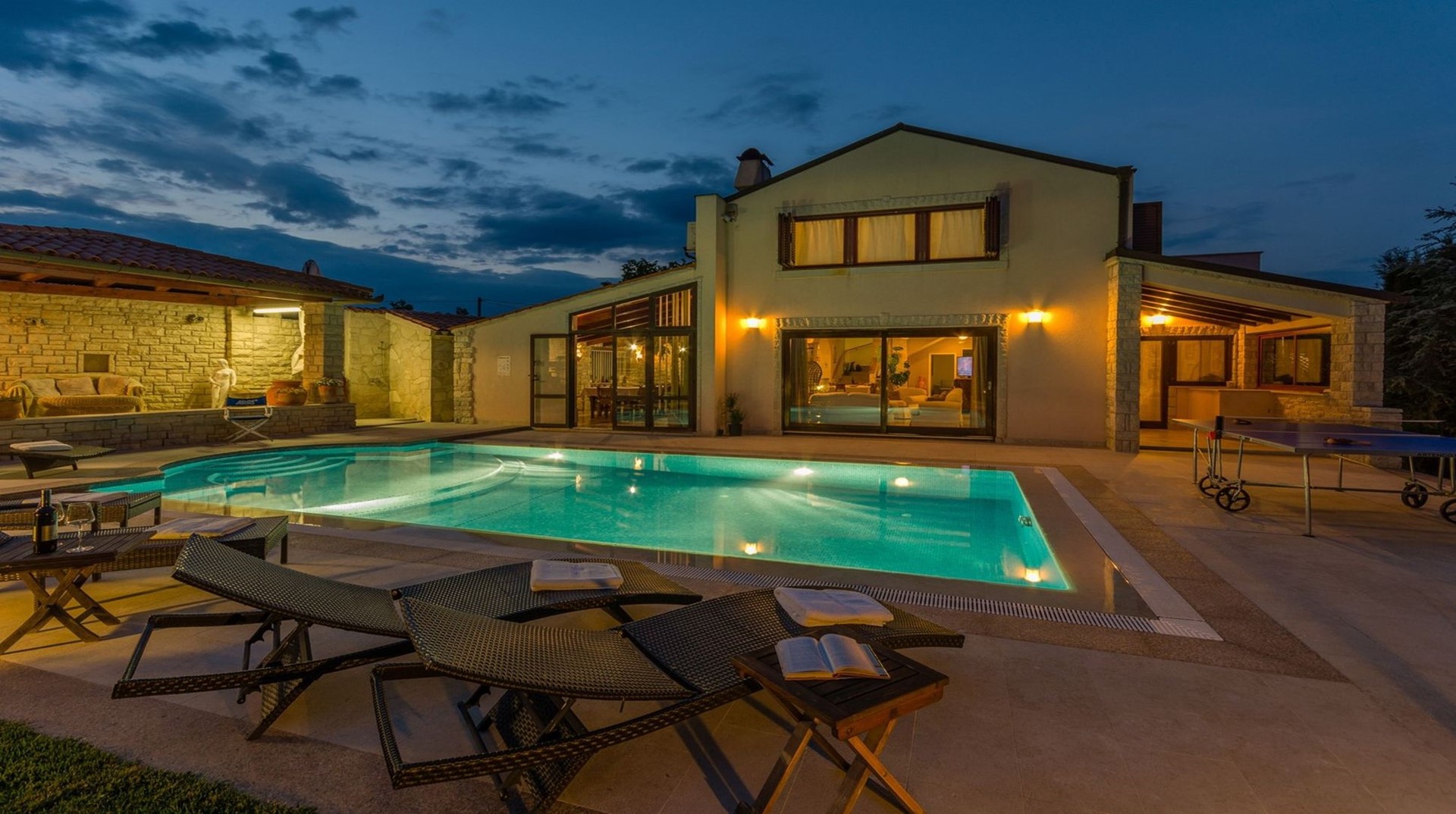 Night view at the private heated pool in the Croatian luxury villa Harmony in Istria designed for the vacation and rent for family and friends