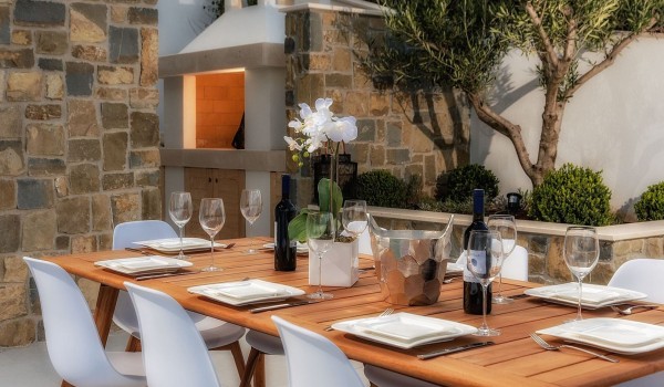 A wooden table set for 10 people on the outdoor terrace of the luxury villa Korcula Prestige on the island of Korcula