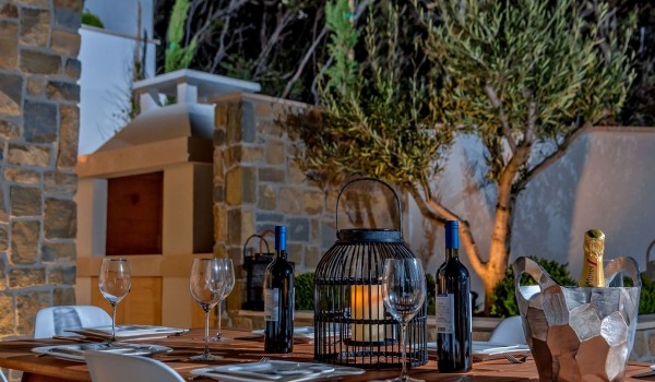 Outdoor fireplace and dining table set for 10 people on the outdoor terrace of the luxury villa Korcula Prestige on the island of Korcula