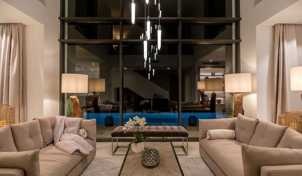 Living room with sofa, coffee table and stool overlooking the pool of the luxury villa Korcula Prestige on the island of Korcula