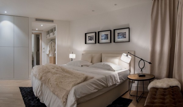 Double bed, wardrobe and leather stools in the bedroom in the luxury villa Korcula Prestige on the island of Korcula