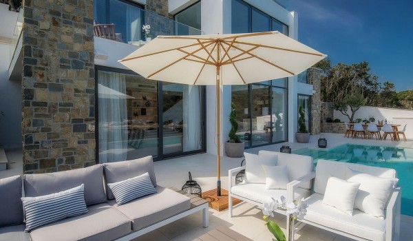 Outdoor terrace with a private pool and seating with a parasol on the outdoor terrace of the luxury villa Korcula Prestige on the island of Korčula