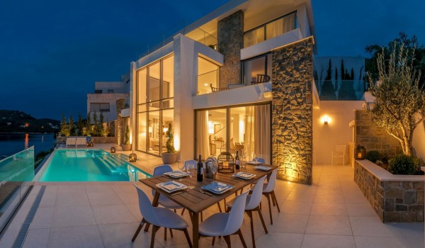 Exterior of the luxury villa Korcula Prestige on the island of Korčula with an outdoor terrace with a private pool and a dining table set for 8 people.