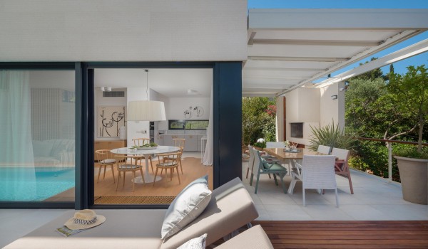 Outdoor dining are with hearth on roofed terrace in family Sutivan luxury villa by the beach with private pool with total privacy.