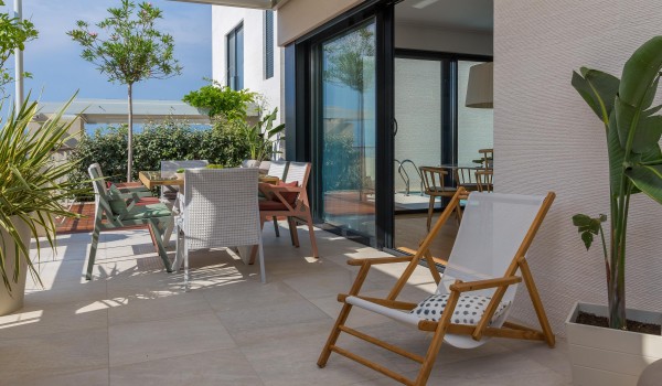 Outdoor dining are with hearth on roofed terrace in family Sutivan luxury villa by the beach with private pool.