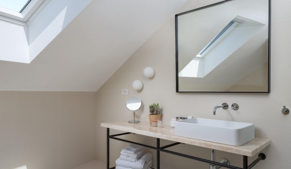 Modern white bathroom with provided towels in luxury holiday rental villa Sutivan by the sea.