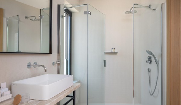 Modern white bathroom with shower in Croatian luxury rental villa Sutivan by the sea.