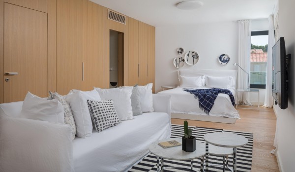 Modern living room with cozy sofa and sea view in Sutivan luxury family villa with private pool by the beach.