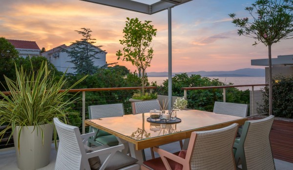 Outdoor dining room on roofed terrace of Croatian rental luxury villa Sutivan by the sea with pool.