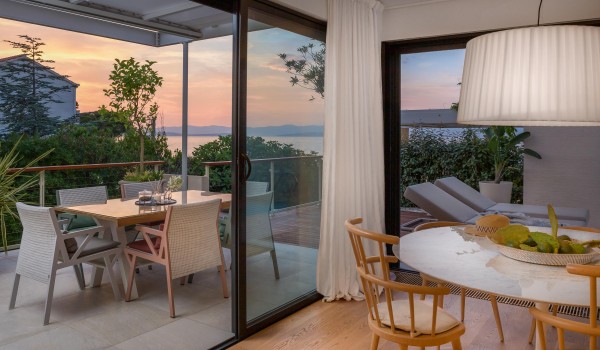 Outdoor dining room on roofed terrace of Croatian rental luxury villa Sutivan by the sea with pool.