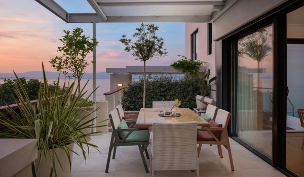 Outdoor dining room on roofed terrace of Croatian rental luxury villa Sutivan by the sea with pool.