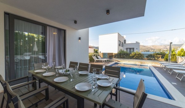 Covered part of the terrace with an outdoor dining table  of a Croatia luxury villa Trogir 2 for vacation and rent