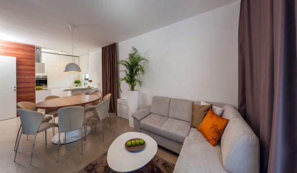 Living room with a  sofa, dining area and a fully equipped kitchen on the ground floor of a Croatia luxury modern villa  Trogir 2 with pool