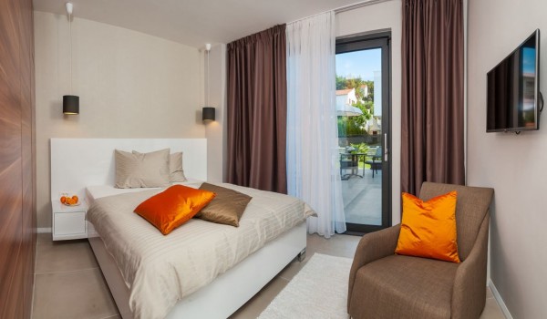 King size bed in a bedroom with private terrace in a Croatia luxury vacation villa with private pool and sauna in Trogir