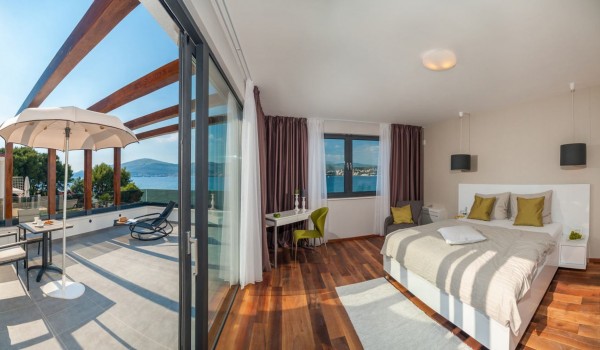 King size bed in a bedroom with private terrace in a Croatia luxury vacation villa with private pool and sauna in Trogir