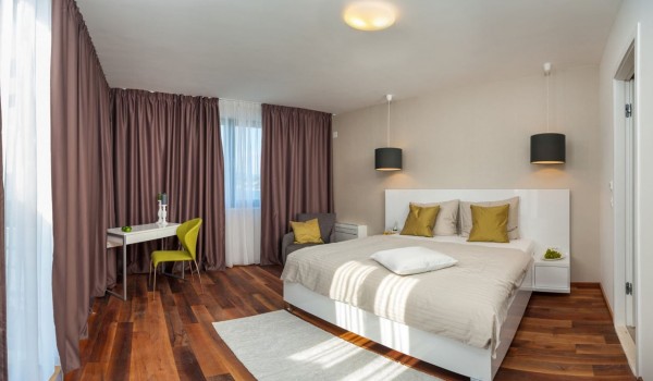 King size bed in a bedroom with private terrace in a Croatia luxury vacation villa with private pool and sauna in Trogir