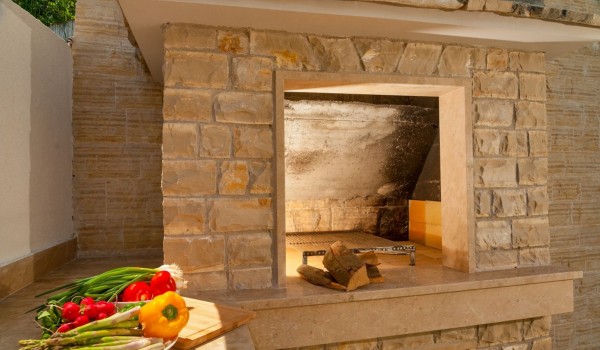 Traditional grill and lawn in the fenced yard of a Croatia  luxury villa Trogir 2 for rent on Ciovo,