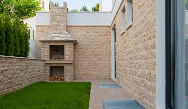 Traditional grill and lawn in the fenced yard of a Croatia  luxury villa Trogir 2 for rent on Ciovo
