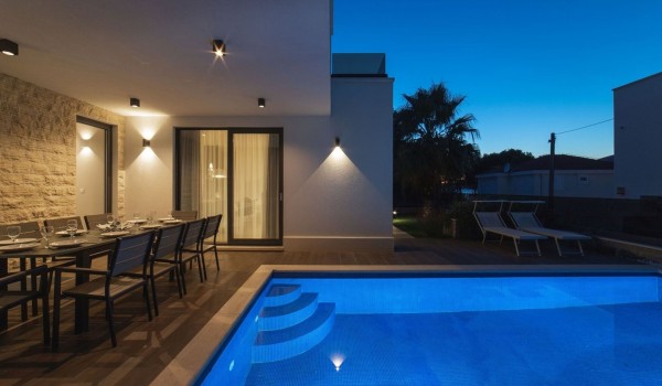 Outdoor dining table by the pool of a Croatia luxury sea view villa Trogir 2 for vacation and rent