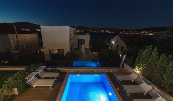 Deck chairs by the pool of a Croatia luxury sea view villa Trogir 2 for vacation and rent