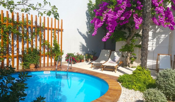 Sun loungers and outdoor swimming pool of a  Croatian luxury holiday villa in Orebic on Peljesac