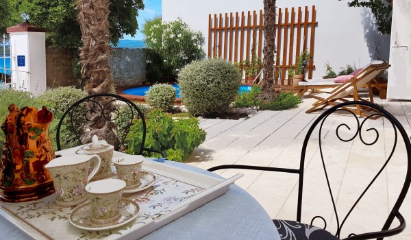 Outdoor terrace surrounded by greenery with a place to sit and relax in a  Croatian luxury villa for rent in Orebic