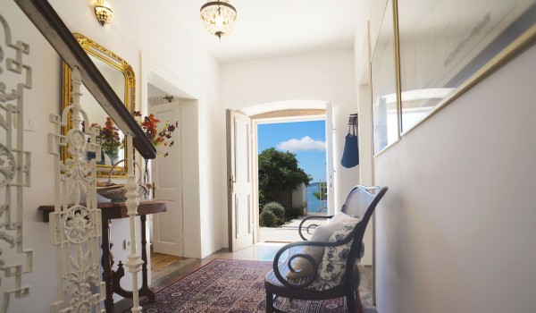Hallway at the entrance to the villa Beach House Orebic with a sofa, interior stairs leading to the first floor and a mirror