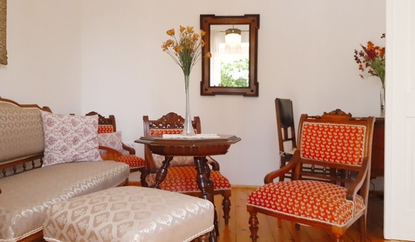 Interior of a holiday villa in Orebic with sofa, chairs, table and mirror of  Croatian luxury pool villa