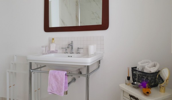 Bathroom with sink, wooden dresser and mirror in a Croatian luxury holiday villa in Orebic