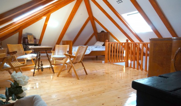 Bedroom with single bed and sitting area with table and chairs inside Croatian luxury pool villa